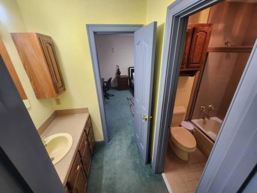 a bathroom with a sink and a toilet and a sink at Southern Large Lake Front Custom Estate, Sleeps 16 in Olive Branch