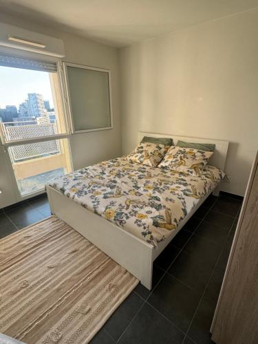 Ce lit se trouve dans une chambre avec vue sur la ville. dans l'établissement Charmant appartement au cœur du centre ville - Marseille, à Marseille