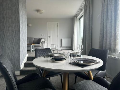 a dining room with a white table and chairs at Aysgarth Falls Hotel & Restaurant in Aysgarth