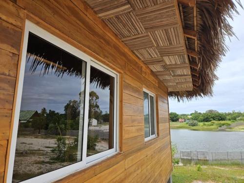 a building with windows with a view of a lake at Villa Tropicale Fy in Mahajanga