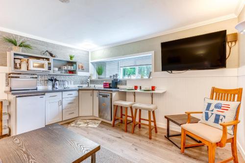 a kitchen with white cabinets and a table and chairs at Charming Updated Retreat Walk to Lake Stevens! in Lake Stevens