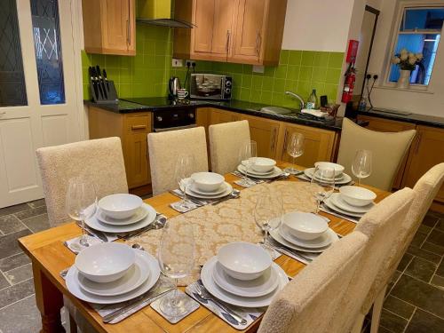 a dining room table with plates and dishes on it at Wall Eden farm House in Cote