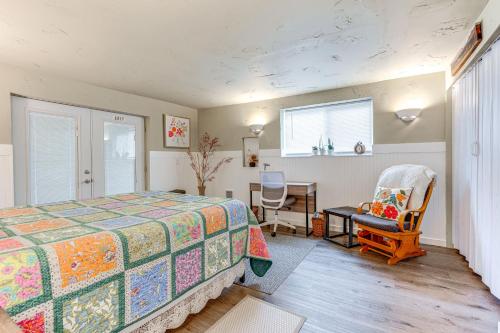 a bedroom with a bed and a desk and a chair at Charming Updated Retreat Walk to Lake Stevens! in Lake Stevens