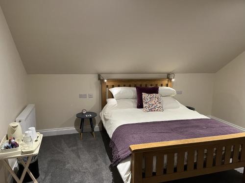 a bedroom with a large bed with a pillow on it at Grainbank Mews in Kirkwall