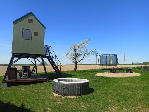 a play area with a tree house and a playground at Posed Kubík in Žďár nad Sázavou