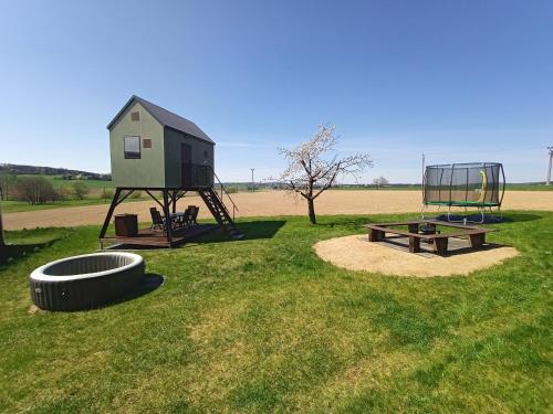 a playground with a house and a picnic table and a bench at Posed Kubík in Žďár nad Sázavou
