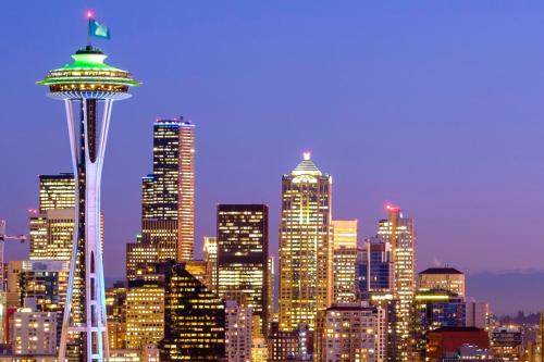 a city skyline with the space needle at night at Astra Hotel, Seattle, a Tribute Portfolio Hotel by Marriott in Seattle