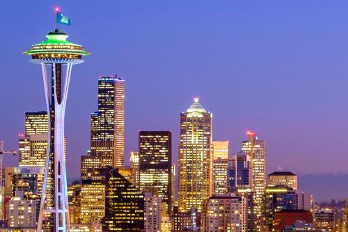 a city skyline with the space needle at night at Astra Hotel, Seattle, a Tribute Portfolio Hotel in Seattle