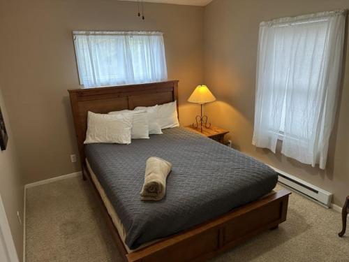 a bedroom with a bed with a towel on it at Tree House , Bagnell Dam area in Lake Ozark