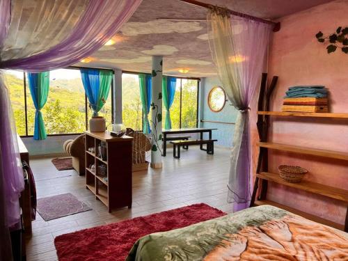 a bedroom with a bed and a large window at Spacious Cloud Studio Mandango Vista in Loja