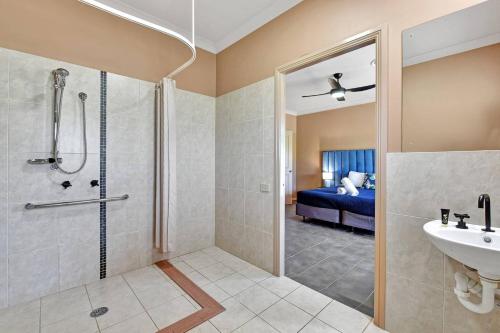 a bathroom with a shower and a sink at The Lodge - Ironstone Estate Hunter Valley in Lovedale