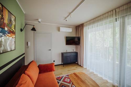 a living room with a couch and a large window at Pod Twisterem in Bielsko-Biała