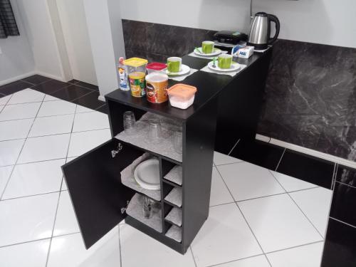 a black table with food on it in a kitchen at POUSADA ALTERNATIVA MANU LAGES suite in Lages