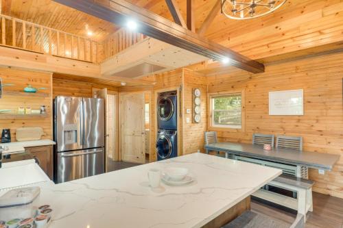 a kitchen with a refrigerator and a counter top at Cozy Hemphill Cabin with Lake Views and Deck! in Hemphill