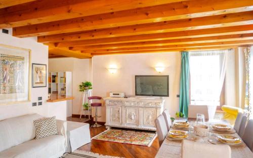 een woonkamer met een tafel en een televisie bij Piccolo Mondo Antico in Verona