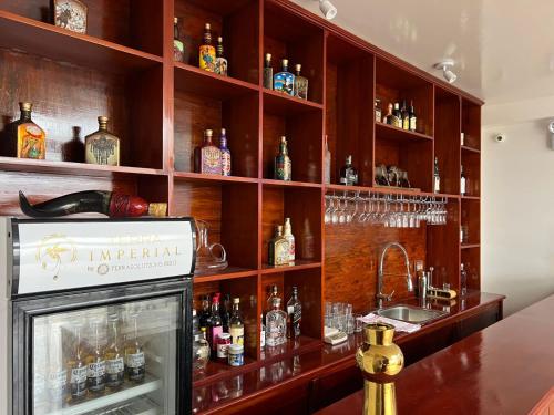 a bar with a lot of bottles of alcohol at Terra Imperial in Chachapoyas