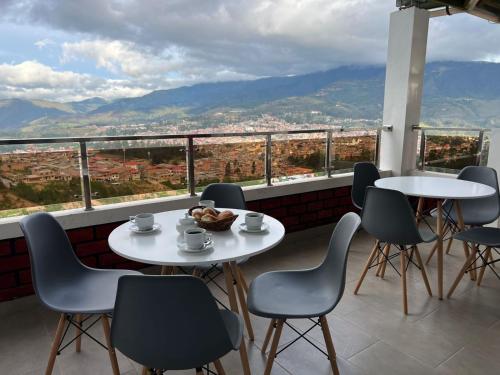 a table and chairs on a balcony with a view at Terra Imperial in Chachapoyas