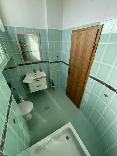 a bathroom with a sink and a toilet and a mirror at Apartment Lucille in Kali