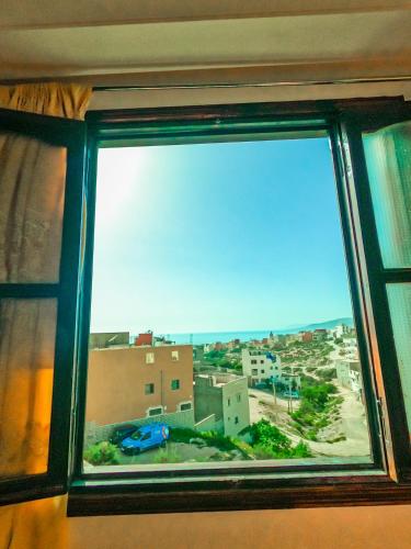 a window with a view of a city at Buena vista morroco GUEST HOUSE in Tamraght Ouzdar