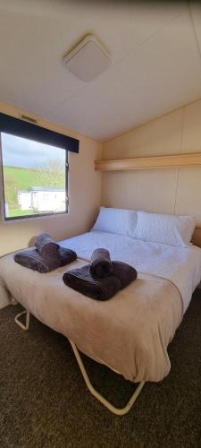 a bedroom with a large bed with towels on it at Coastal Retreat Newquay NB91 in Newquay