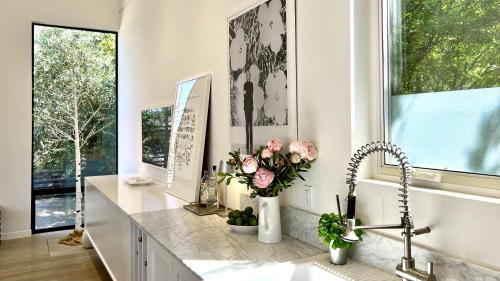 a kitchen with a counter with flowers and a sink at Modern Sonoma Home w Private Pool - Valley Vineyards in Healdsburg