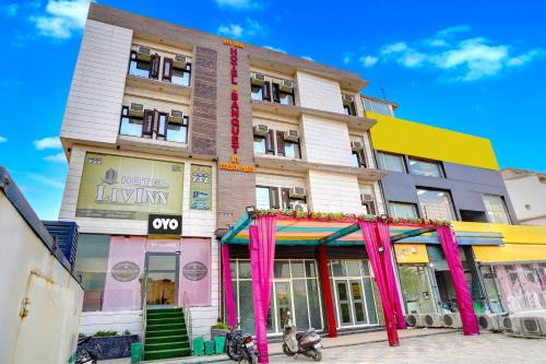 a tall building with pink curtains in front of it at Collection O Hotel Liv Inn in Ghaziabad