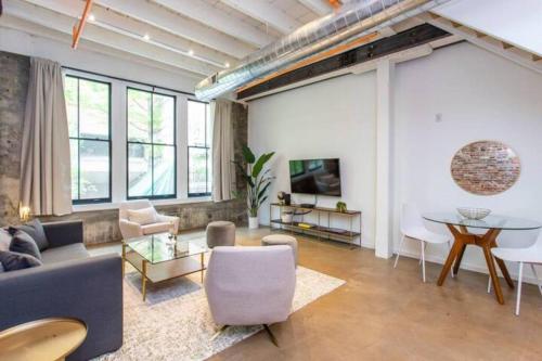a living room with a couch and a table at Inventors' Loft - Stay in the Heart of it All in Philadelphia