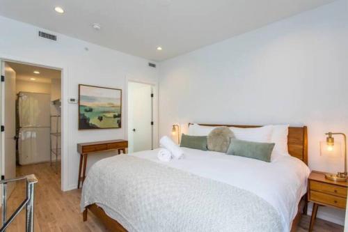 a bedroom with a large white bed and a bathroom at Inventors' Loft - Stay in the Heart of it All in Philadelphia