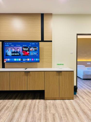 a hospital room with a large flat screen tv at STAR HOTEL in Tawau