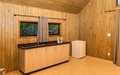 a kitchen with a counter and a refrigerator in a room at Hotel Brisa do Japi in Cabreúva
