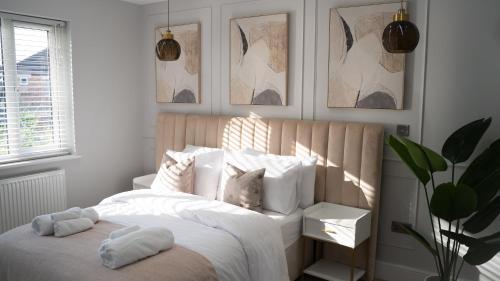 a bedroom with a bed with white sheets and pillows at Oakleigh House, 3 bedroom, free parking in East Barnet