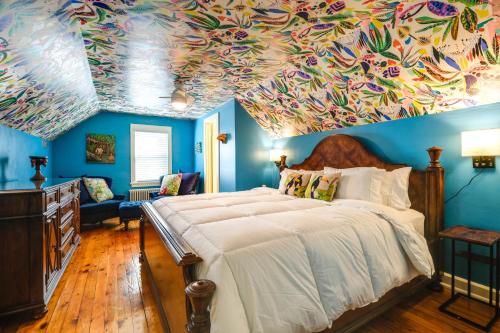 a bedroom with a large bed with a painting on the ceiling at Colorful Roanoke Vacation Rental with Hot Tub! in Roanoke