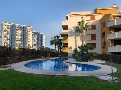 een zwembad in een tuin naast sommige gebouwen bij Apartment in Punta Prima (Torrevieja) 200m to Sea in Punta Prima