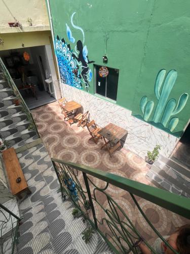 two benches in front of a building with graffiti at Multiverso Hostel in Lençóis