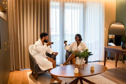Un uomo e una donna seduti in una stanza d'albergo di Golden Rock Dive and Nature Resort a Oranjestad