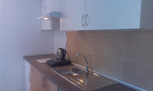 a kitchen with a sink and aaucet at Holiday Home El Romani in Calafell