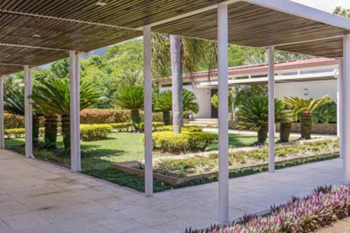 a courtyard of a building with plants and trees at Balmoral House With Pool & Jacuzzi in La Pintada