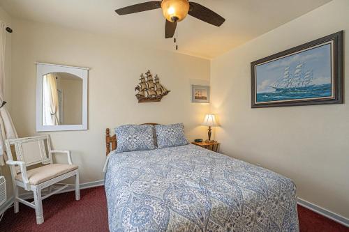 a bedroom with a bed and a ceiling fan at Jensen's RV Park and Motel in South Haven
