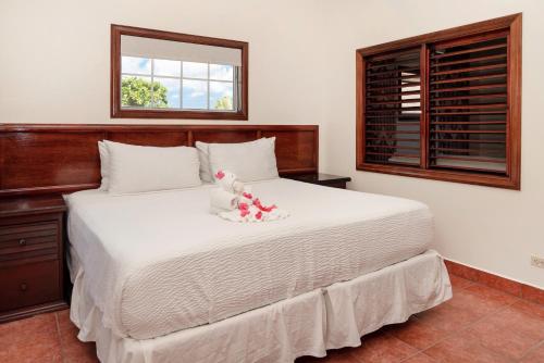 a bedroom with a white bed with a stuffed animal on it at X'tan Ha- The Waterfront in San Pedro