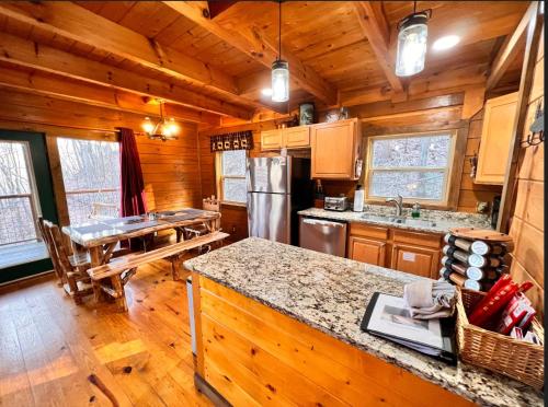 a kitchen with wooden walls and a wooden floor at Stairway to Heaven - 3 Master Suite, Location, Privacy, Firepit in Gatlinburg
