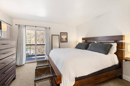 a bedroom with a large bed and a window at Woodbridge 34 C in Snowmass Village
