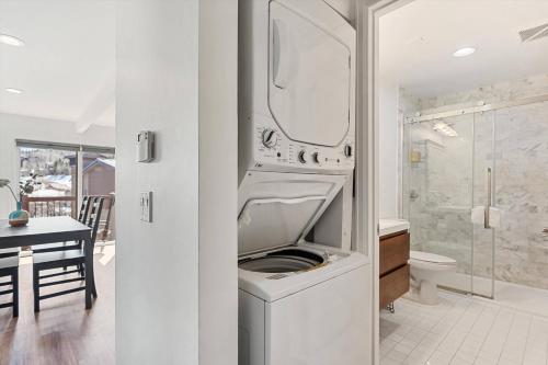 a washing machine with its door open in a bathroom at Woodbridge 34 C in Snowmass Village