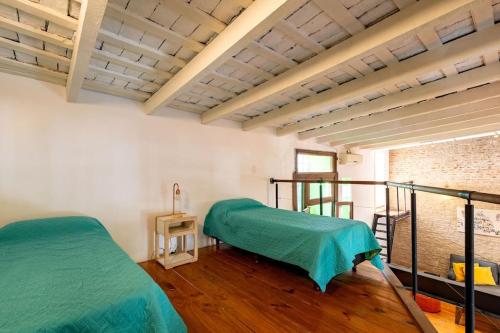 une chambre avec deux lits dans une pièce dans l'établissement Casa Palermo Soho. 2 pisos, terraza 360°, piscina y parrilla, à Buenos Aires