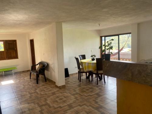a dining room with a yellow table and chairs at Casa campestre in Jericó