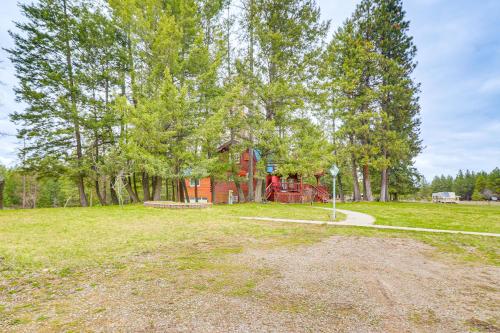 a park with a playground in the middle of a field at Secluded Bigfork Cabin with Yard and Fire Pit! in Bigfork