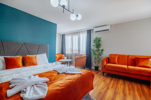 a bedroom with an orange bed and a couch at Taksim Wonder Suites in Istanbul