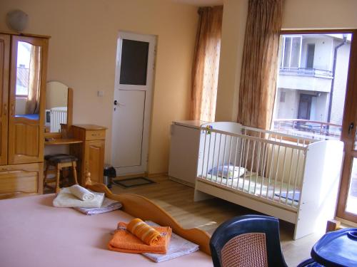 a baby room with a crib and a baby crib at Guest House "Zora - Sarafovo" in Burgas