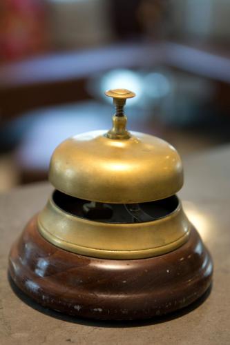 a small brown jar with a gold top on a table at Hotel St. Josef in Zürich