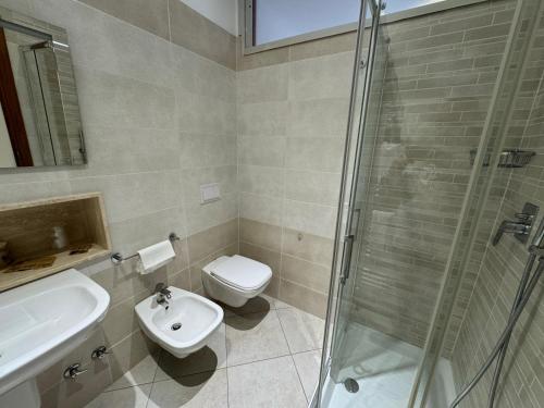 a bathroom with a sink and a toilet and a shower at Hotel Holidays in Roccaraso