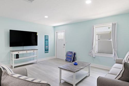 a living room with a tv and a couch and a table at Superb Bonita Springs Residence Near Downtown in Bonita Springs